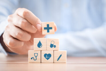 Health Insurance Concept Idea Presentation Using Blocks with Medicine Icons