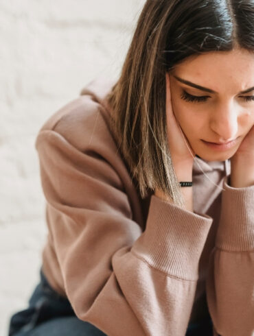 Sad woman sitting in doubt