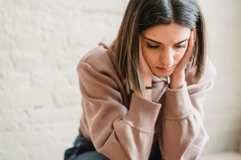 Sad woman sitting in doubt