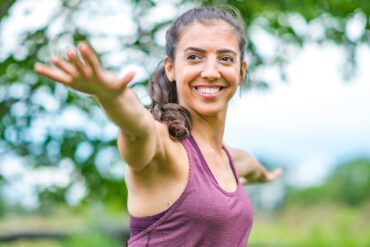 Teacher Leading Outdoor Yoga Retreat Practice