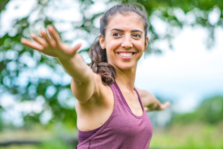 Teacher Leading Outdoor Yoga Retreat Practice