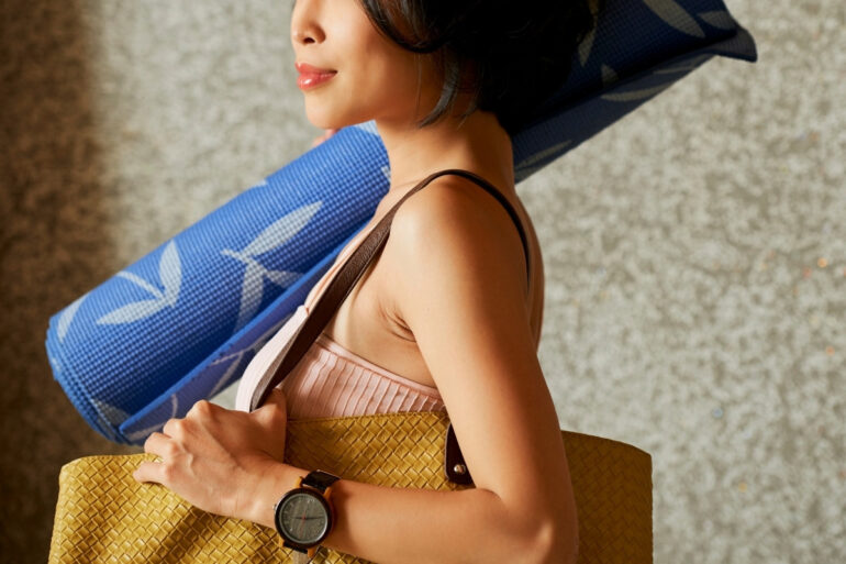 Woman Carrying Bag and Yoga Mat