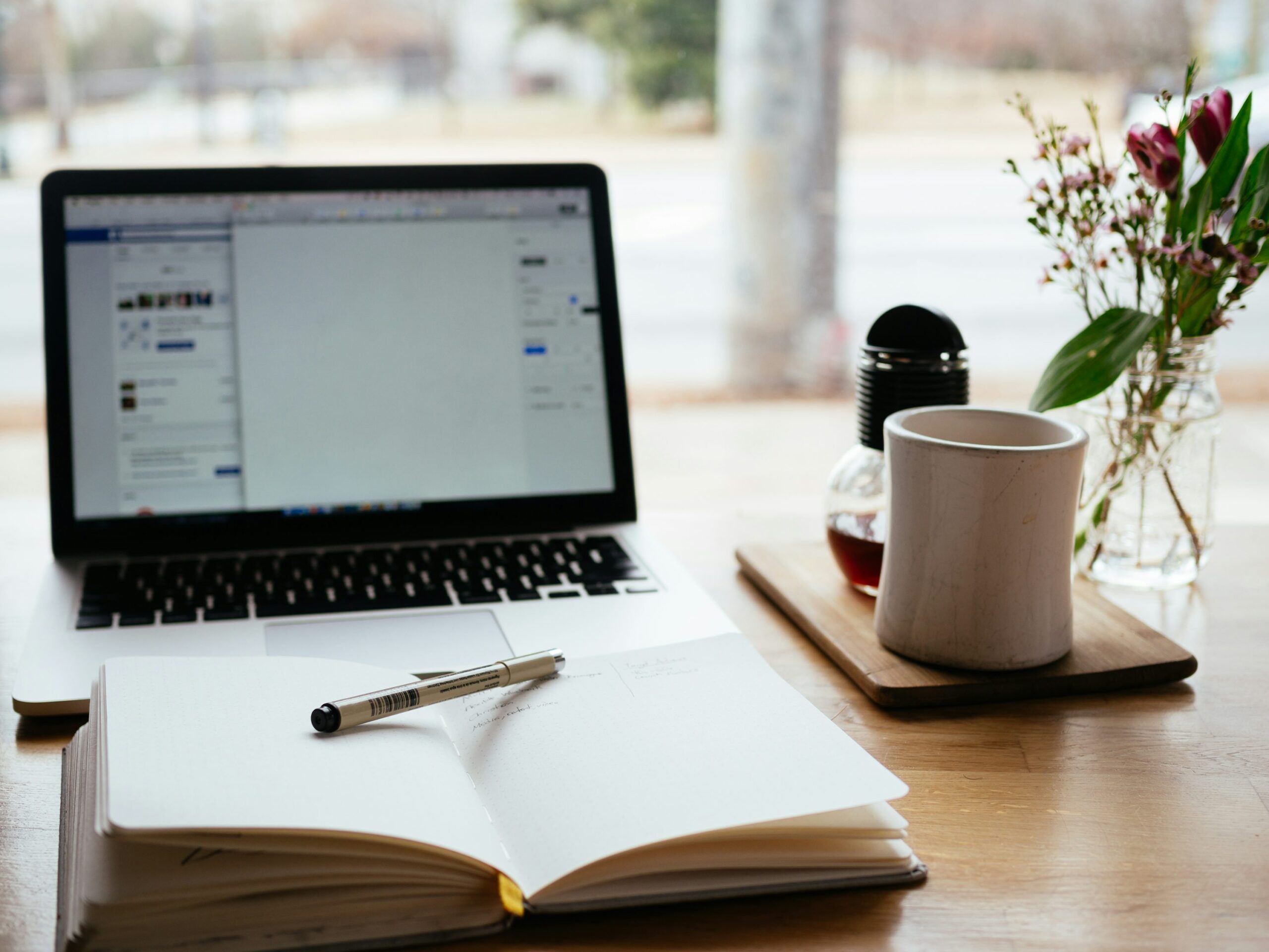 journal with laptop and coffee