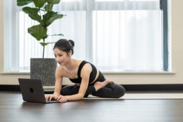 yoga teacher creating website on her laptop