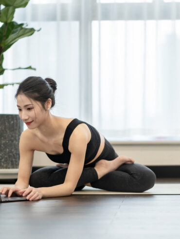 yoga teacher creating website on her laptop