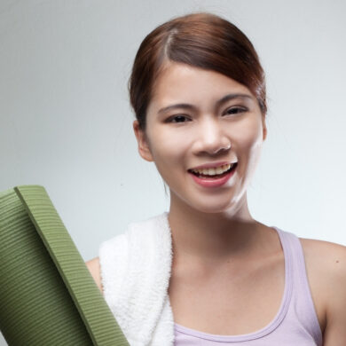 yoga teacher holding her mat