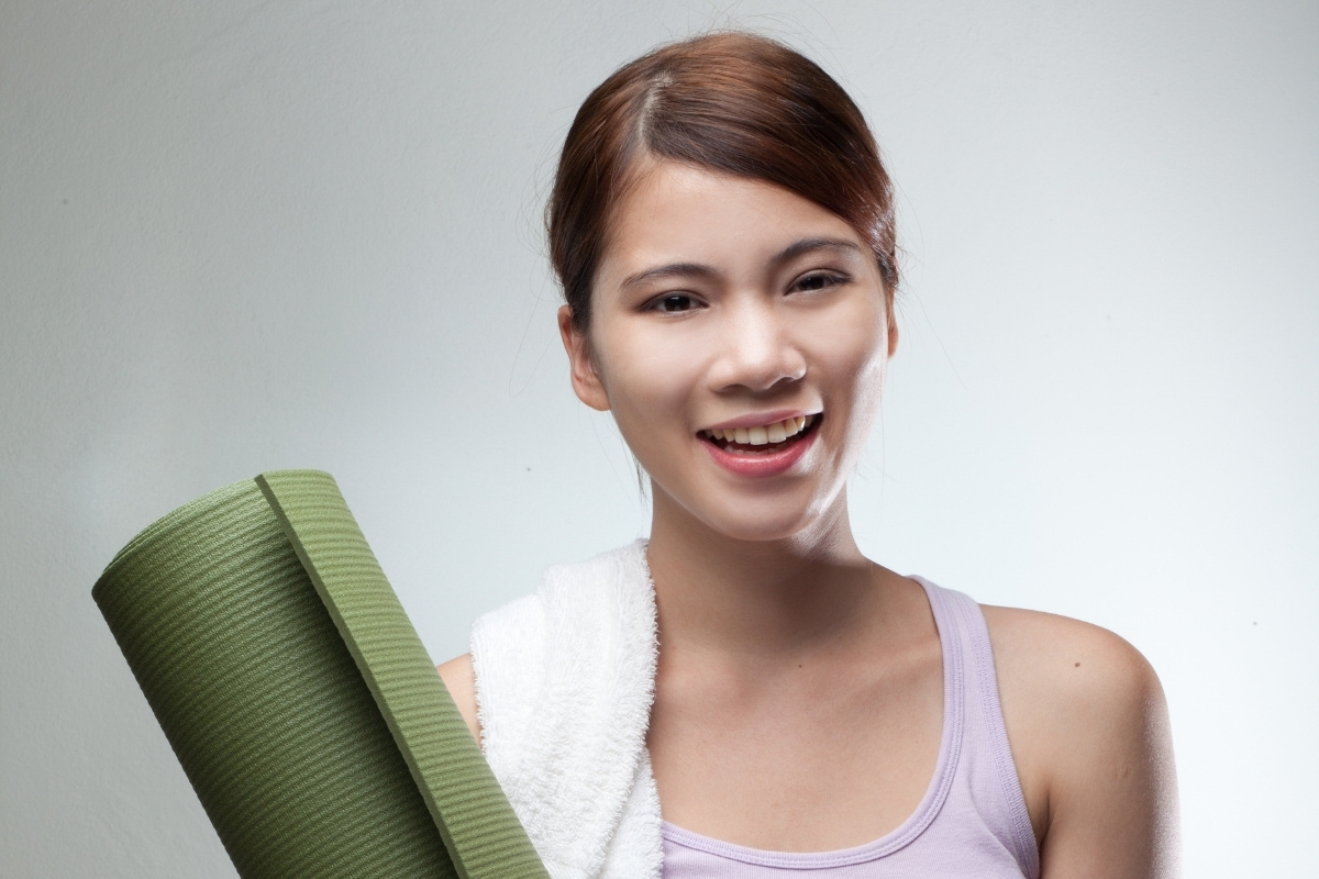 yoga teacher holding her mat