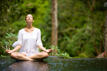 yoga teacher leading morning meditation in overseas retreat