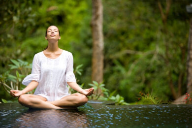 yoga teacher leading morning meditation in overseas retreat