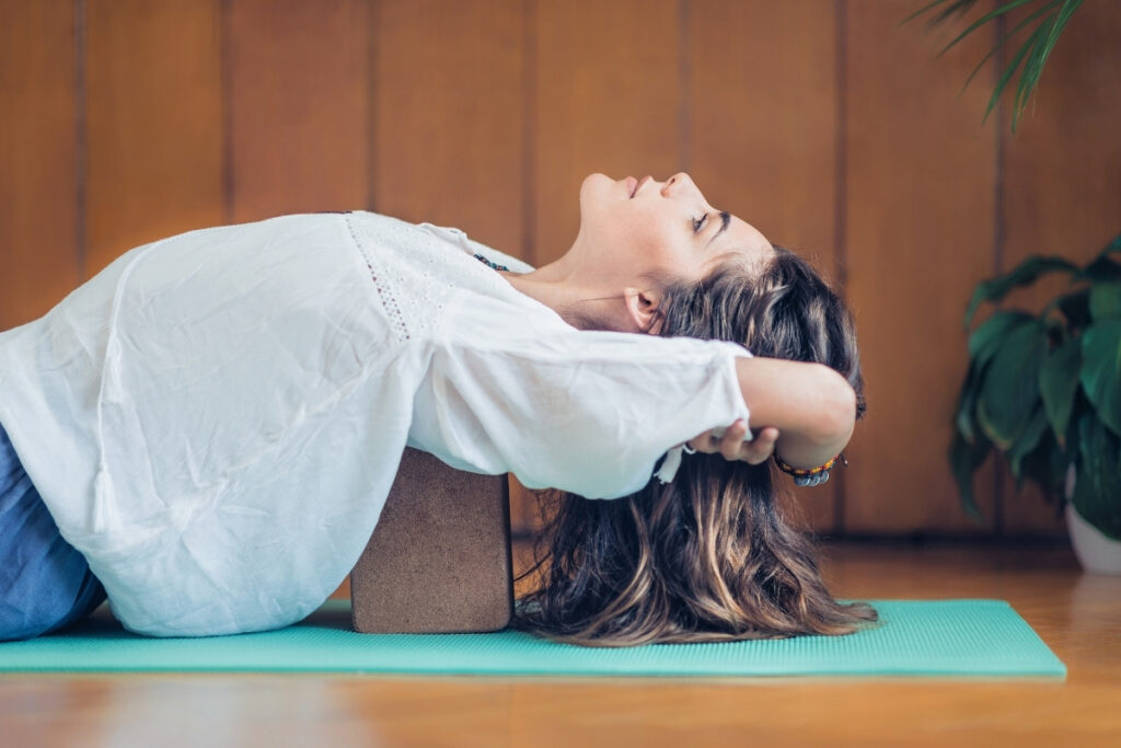 Woman Practicing Yoga Using Blocks