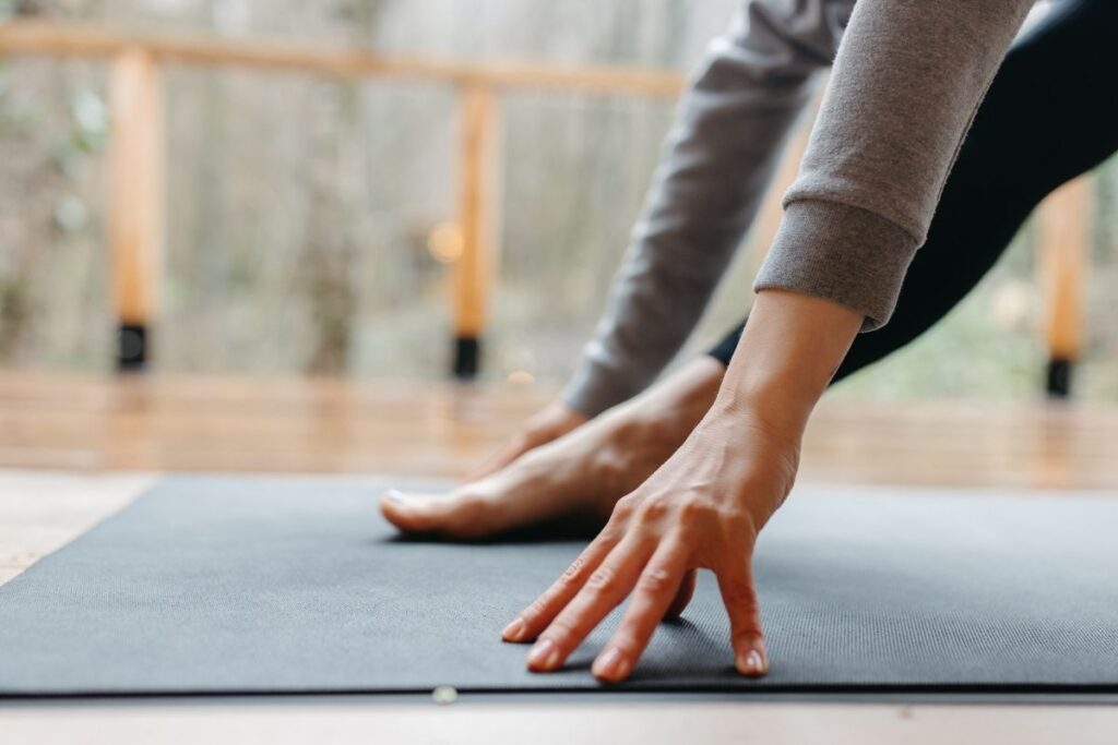 fingers gripping on a yoga mat